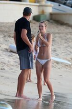 Caroline wozniacki slips into a white bikini while enjoying a beach day with husband david lee