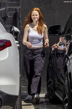 Madelaine Petsch sports a white tank top and cargo pants while she grabs some food and an iced
