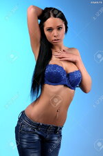 28215729 sexy busty young girl posing topless in a jeans and blue bra Stock Photo