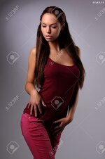 20764420 sexy busty young girl posing in a red shirt and a jeans Stock Photo