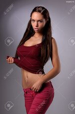 20764423 sexy busty young girl posing in a red shirt and a jeans Stock Photo