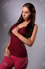 20764425 sexy busty young girl posing in a red shirt and a jeans Stock Photo