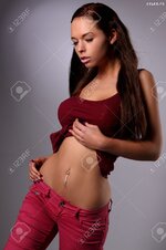 20764426 sexy busty young girl posing in a red shirt and a jeans Stock Photo