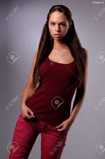 21511853 sexy busty young girl posing in a red shirt and a jeans Stock Photo