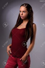 21511854 sexy busty young girl posing in a red shirt and a jeans Stock Photo